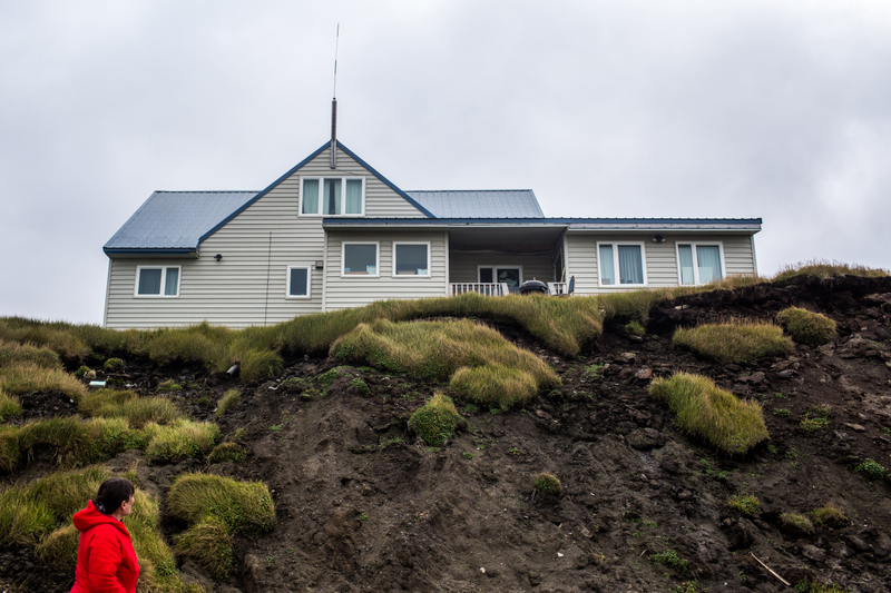 UTQIAGVIK, ALASKA - MONDAY, SEPTEMBER 21, 2017: Anne Jensen, Arctic Anthropologist and Archaeologist with UIC Sciences in Utqiaġvik, examines a house perched atop Ukkuqsi, a rapidly-eroding Inupiat archaeological site located in Utqiaġvik. Photograph: Ash Adams/Gizmodo